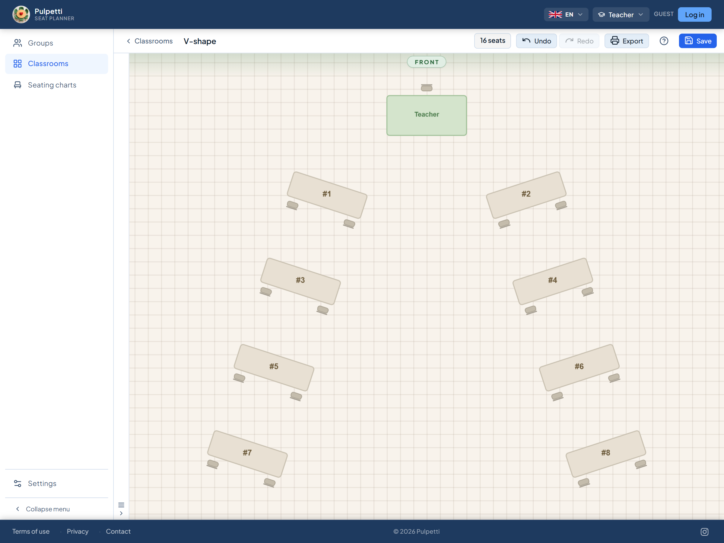 Classroom floor plan in a V-shape: two-person desks in two angled wings opening toward the back, students facing the teacher's desk